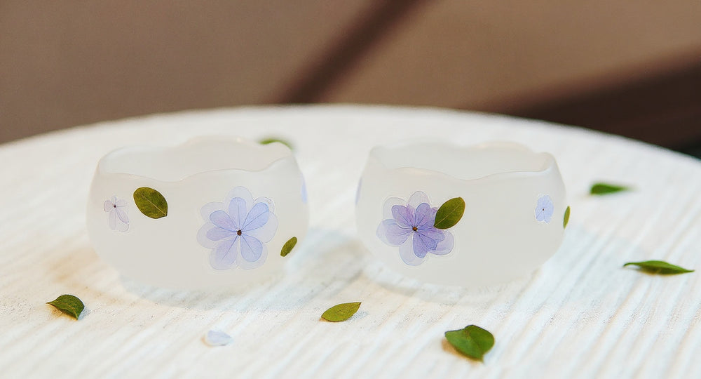 Handmade Floating Flower Teacup Set with frosted glass and real blue hydrangea on linen tray.