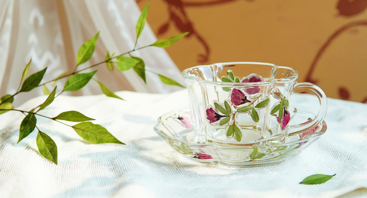 Handmade Glass Cup and Saucer Set with real pressed flowers on linen tablecloth