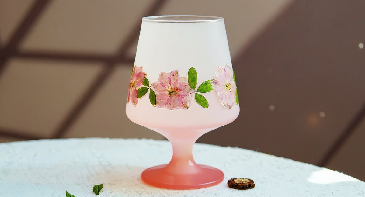Handcrafted Pink Ombre Stem Glass with real preserved flowers on marble tabletop