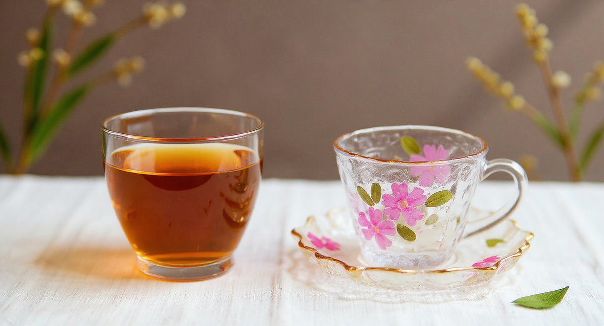 Handcrafted floral resin tea cup and saucer set with gold rim on linen cloth.