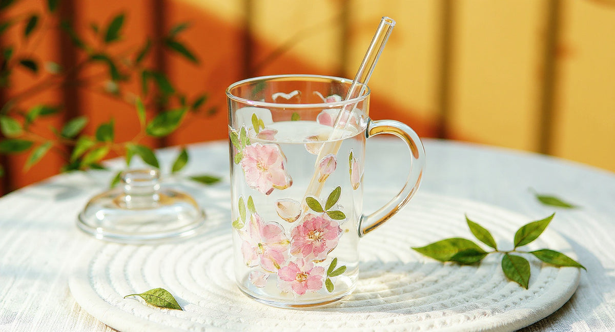 Handcrafted Preserved Flower Glass Cup with ceramic tray, dried petals, and eucalyptus on marble.