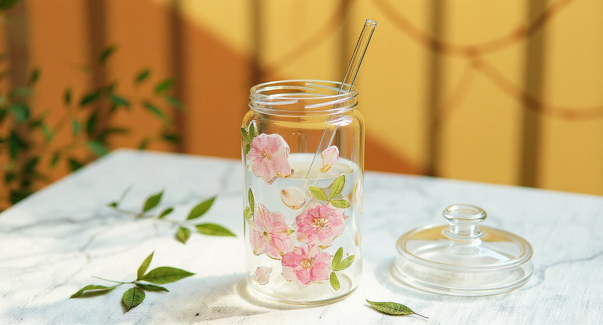Handcrafted Preserved Flower Glass Cup 400ml with dust-proof lid and glass straw on marble