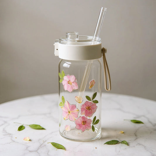 Hero image of a unique glass cup with dried flowers on a marble surface, accompanied by loose dried botanicals in soft natural lighting.