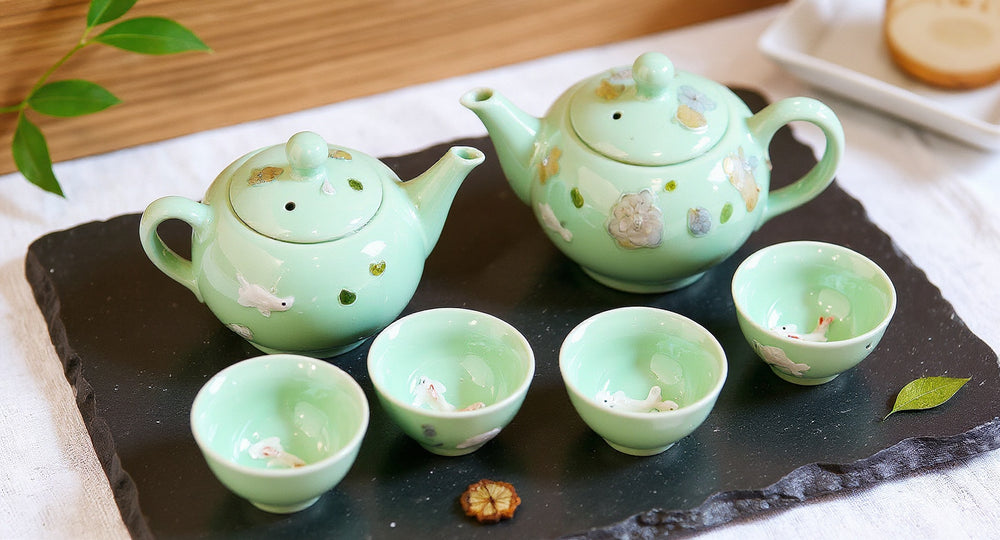 Handmade Celadon Tea Set with 3D Koi Fish Teapot and six cups on slate tray with winter jasmine.