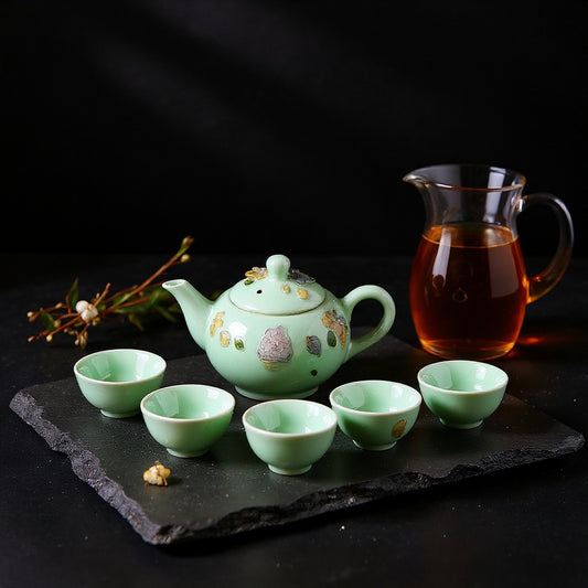 Hero image of a jade-green celadon porcelain tea set with winter jasmine petals and amber tea on a dark slate tray against a bold jade-to-charcoal gradient background.