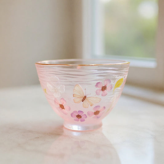 Luxury handmade gradient pink butterfly glass mug on marble surface with soft bokeh
