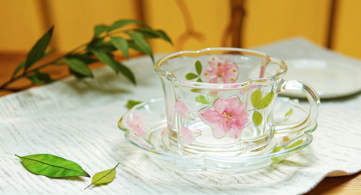 Pressed Flower Glass Cup & Saucer with raised floral relief on cream linen.