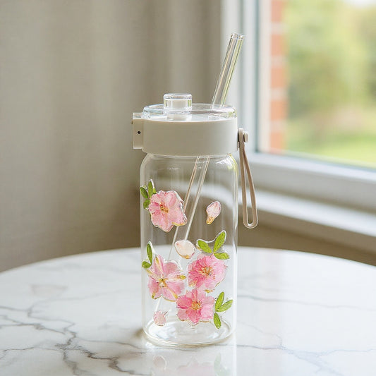 Cottagecore glass tumbler with preserved flowers on a marble surface