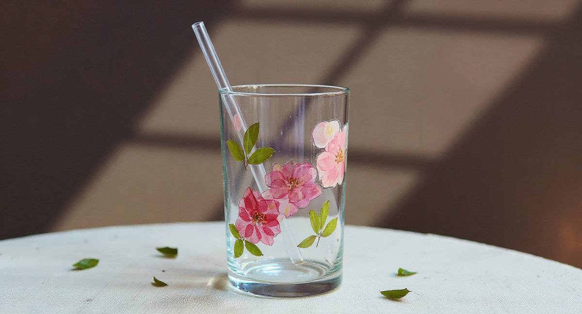 Handcrafted Pressed Flower Glass Tumbler 400ml with straw on brass tray and linen.